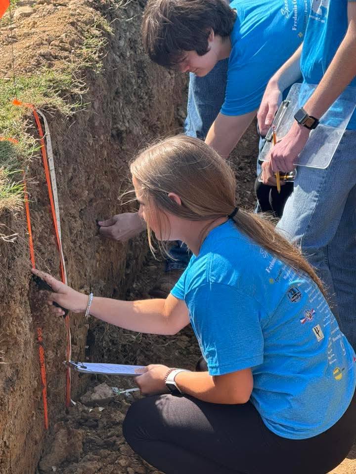 student looking at soil profile